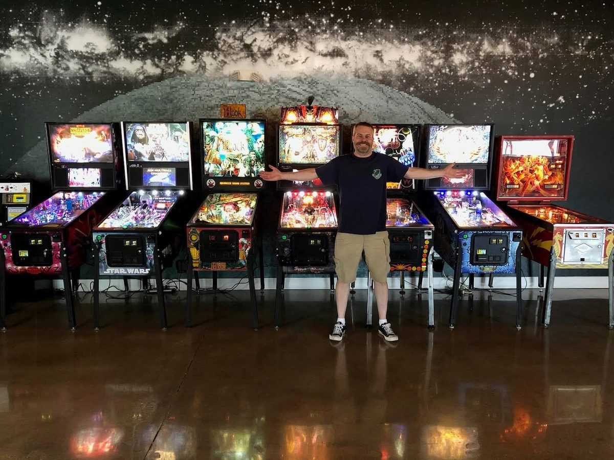 Dan Farrell with his lineup of pinball machines at Center of the Universe Brewing in Ashland, VA